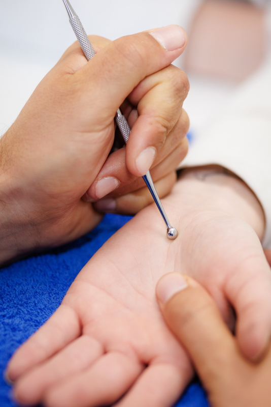 Der Fotograf dokumentiert eine therapeutische Sitzung, sei es in der Logopädie oder Physiotherapie. In der Logopädie arbeitet der Therapeut mit einem Patienten an Sprachübungen, während in der Physiotherapie manuelle Therapien durchgeführt werden. Der Fokus liegt auf der professionellen Behandlung und der ruhigen, vertrauensvollen Praxisatmosphäre.